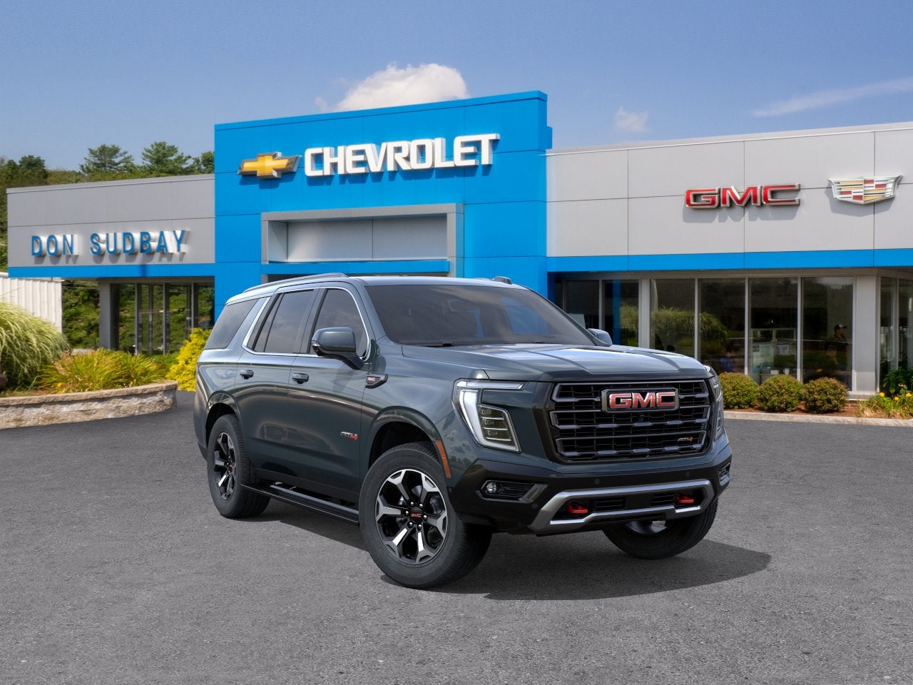 2026 GMC Yukon AT4 Ultimate in Midnight Pine — front three-quarter view